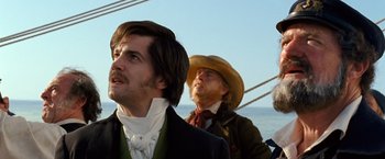 Movie still from “Cloud Atlas” (2012), directed by Lilly Wachowski – Two men are standing next to each other on a boat; Close Up shot, Low angle