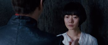 Movie still from “Cloud Atlas” (2012), directed by Lilly Wachowski – A young woman looking into a mirror while a man looks on; Close Up shot, Over the shoulder angle