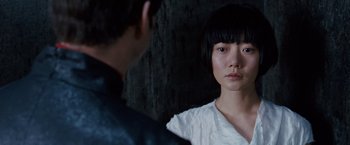 Movie still from “Cloud Atlas” (2012), directed by Lilly Wachowski – A young woman with bangs looking into a mirror; Close Up shot, Over the shoulder angle