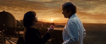 Movie still from “Cloud Atlas” (2012), directed by Lilly Wachowski – A man and a woman standing next to each other in front of a sunset; Medium shot, Over the shoulder angle