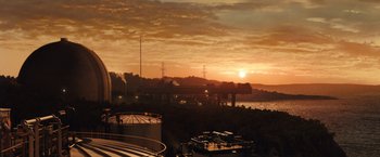 Movie still from “Cloud Atlas” (2012), directed by Lilly Wachowski – The sun is setting over a river with a bridge in the background; Extreme Wide shot, Low angle