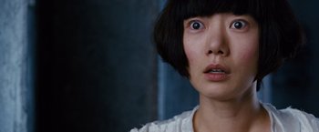 Movie still from “Cloud Atlas” (2012), directed by Lilly Wachowski – A person with short black hair; Close Up shot, Over the shoulder angle