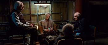 Movie still from “Cloud Atlas” (2012), directed by Lilly Wachowski – An older woman sitting in a chair with a group of older people; Wide shot, High angle