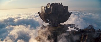 Movie still from “Cloud Atlas” (2012), directed by Lilly Wachowski – An aerial view of a building with a sky filled with clouds; Extreme Wide shot, Overhead angle