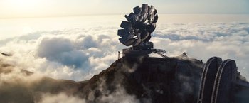 Movie still from “Cloud Atlas” (2012), directed by Lilly Wachowski – A sculpture of a windmill on top of a mountain; Extreme Wide shot, Low angle