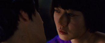 Movie still from “Cloud Atlas” (2012), directed by Lilly Wachowski – A young woman looking at a young man with dark hair; Close Up shot, Over the shoulder angle
