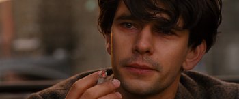 Movie still from “Cloud Atlas” (2012), directed by Lilly Wachowski – A person holding a cigarette; Close Up shot, Over the shoulder angle
