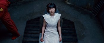 Movie still from “Cloud Atlas” (2012), directed by Lilly Wachowski – A woman sitting on top of a chair wearing a white dress; Medium shot, Overhead angle