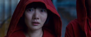 Movie still from “Cloud Atlas” (2012), directed by Lilly Wachowski – A woman in a red hooded jacket looking at the camera; Close Up shot, High angle