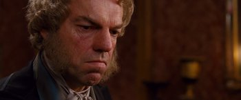 Movie still from “Cloud Atlas” (2012), directed by Lilly Wachowski – A man with long blonde hair stares into the distance; Close Up shot, Low angle