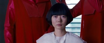 Movie still from “Cloud Atlas” (2012), directed by Lilly Wachowski – A woman with a short black hair sitting in front of a window; Close Up shot, Low angle