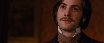 Movie still from “Cloud Atlas” (2012), directed by Lilly Wachowski – A person with a mustache; Close Up shot, Over the shoulder angle
