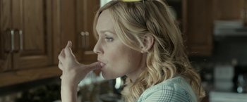 Movie still from “Clown” (2014), directed by Jon Watts – A blonde woman with a yellow hair clip on her head; Close Up shot, Over the shoulder angle