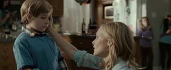 Movie still from “Clown” (2014), directed by Jon Watts – A young woman is holding a boy's hand; Close Up shot, Over the shoulder angle