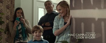 Movie still from “Clown” (2014), directed by Jon Watts – A man and a woman standing next to a young boy; Medium shot, Over the shoulder angle