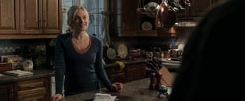 Movie still from “Clown” (2014), directed by Jon Watts – A woman sitting at a kitchen counter in a kitchen; Medium shot, Over the shoulder angle