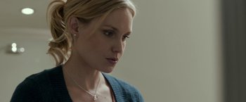 Movie still from “Clown” (2014), directed by Jon Watts – A beautiful blonde woman wearing a blue sweater; Close Up shot, Over the shoulder angle