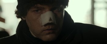 Movie still from “Clown” (2014), directed by Jon Watts – A person with a bandage on his face; Close Up shot, Low angle
