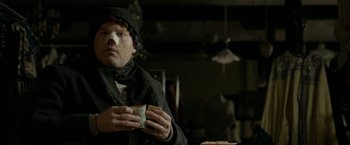 Movie still from “Clown” (2014), directed by Jon Watts – A man holding a cup in his hands; Close Up shot, Over the shoulder angle