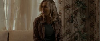 Movie still from “Clown” (2014), directed by Jon Watts – A woman with blonde hair wearing a brown shirt; Medium shot, Over the shoulder angle