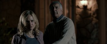 Movie still from “Clown” (2014), directed by Jon Watts – A man and a woman standing next to each other; Medium shot, Over the shoulder angle