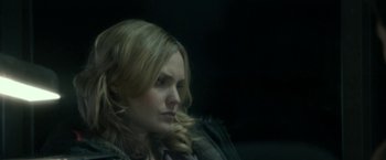 Movie still from “Clown” (2014), directed by Jon Watts – A woman sitting in front of a black background; Close Up shot, Over the shoulder angle