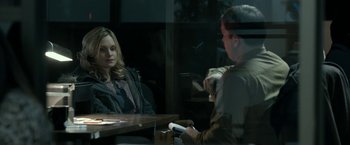 Movie still from “Clown” (2014), directed by Jon Watts – Two people sitting at a table in front of each other; Medium shot, Over the shoulder angle