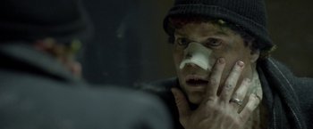 Movie still from “Clown” (2014), directed by Jon Watts – A man with a bandage on his face looking in a mirror; Close Up shot, Over the shoulder angle