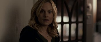 Movie still from “Clown” (2014), directed by Jon Watts – A woman with long blonde hair looking at the camera; Close Up shot, Over the shoulder angle