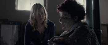 Movie still from “Clown” (2014), directed by Jon Watts – A woman sitting next to a man in front of a window; Medium shot, Over the shoulder angle