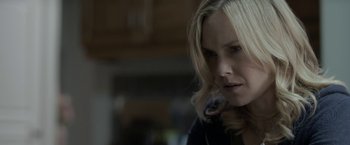 Movie still from “Clown” (2014), directed by Jon Watts – A woman with blonde hair is looking at the camera; Close Up shot, Over the shoulder angle