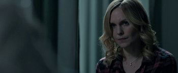 Movie still from “Clown” (2014), directed by Jon Watts – A woman with long blonde hair wearing a red and black plaid shirt; Close Up shot, Over the shoulder angle