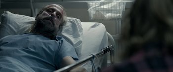 Movie still from “Clown” (2014), directed by Jon Watts – An older man laying in a hospital bed; Close Up shot, Over the shoulder angle