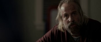 Movie still from “Clown” (2014), directed by Jon Watts – An older man with a beard and a mustache; Close Up shot, Over the shoulder angle