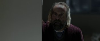 Movie still from “Clown” (2014), directed by Jon Watts – A man with long hair and a beard looking at a computer screen; Close Up shot, Over the shoulder angle