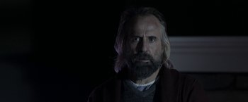 Movie still from “Clown” (2014), directed by Jon Watts – A man with long hair and a beard stares at the camera; Close Up shot, Low angle