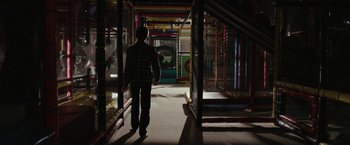 Movie still from “Clown” (2014), directed by Jon Watts – A man walking down a hallway in a building; Wide shot, High angle