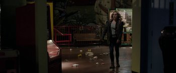 Movie still from “Clown” (2014), directed by Jon Watts – A woman standing in front of a bunch of garbage; Wide shot, High angle