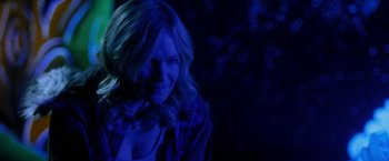 Movie still from “Clown” (2014), directed by Jon Watts – A woman with blonde hair is in the dark; Close Up shot, Over the shoulder angle