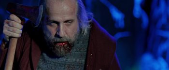 Movie still from “Clown” (2014), directed by Jon Watts – A person with blood on his face; Close Up shot, Low angle