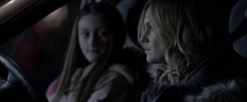 Movie still from “Clown” (2014), directed by Jon Watts – Two young women sitting next to each other in a car; Close Up shot, Over the shoulder angle