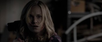 Movie still from “Clown” (2014), directed by Jon Watts – A woman with long blonde hair stares into the camera; Close Up shot, Over the shoulder angle
