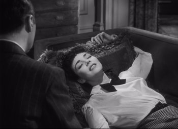 Movie still from “Cluny Brown” (1946), directed by Ernst Lubitsch – A man and a woman laying on a couch; Medium shot, Overhead angle
