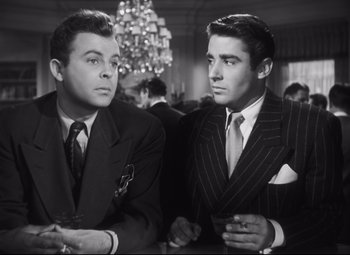 Movie still from “Cluny Brown” (1946), directed by Ernst Lubitsch – A couple of men sitting next to each other at a table; Medium shot, Low angle