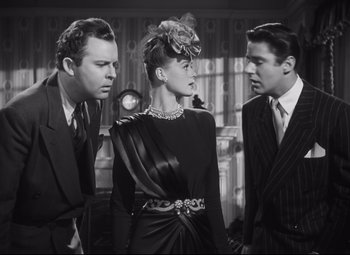 Movie still from “Cluny Brown” (1946), directed by Ernst Lubitsch – A man and two women standing next to each other; Medium shot, Low angle