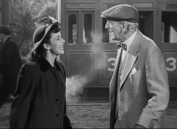 Movie still from “Cluny Brown” (1946), directed by Ernst Lubitsch – An older man and a young woman standing next to each other; Medium shot, High angle