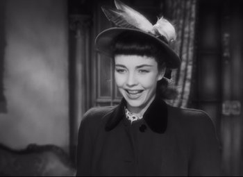 Movie still from “Cluny Brown” (1946), directed by Ernst Lubitsch – A woman wearing a hat with a bird perched on top of her head; Close Up shot, High angle