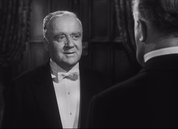 Movie still from “Cluny Brown” (1946), directed by Ernst Lubitsch – A man in a tuxedo looking at himself in the mirror; Close Up shot, Over the shoulder angle