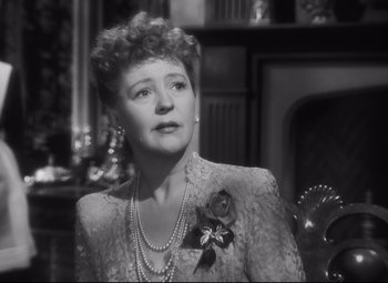 Movie still from “Cluny Brown” (1946), directed by Ernst Lubitsch – An old photo of a woman in a dress; Close Up shot, Over the shoulder angle