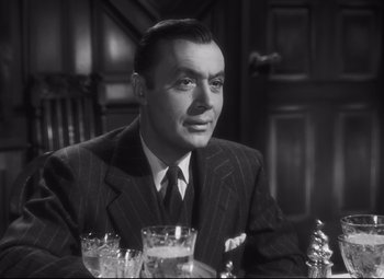Movie still from “Cluny Brown” (1946), directed by Ernst Lubitsch – A man sitting at a table with a glass of water; Close Up shot, Low angle